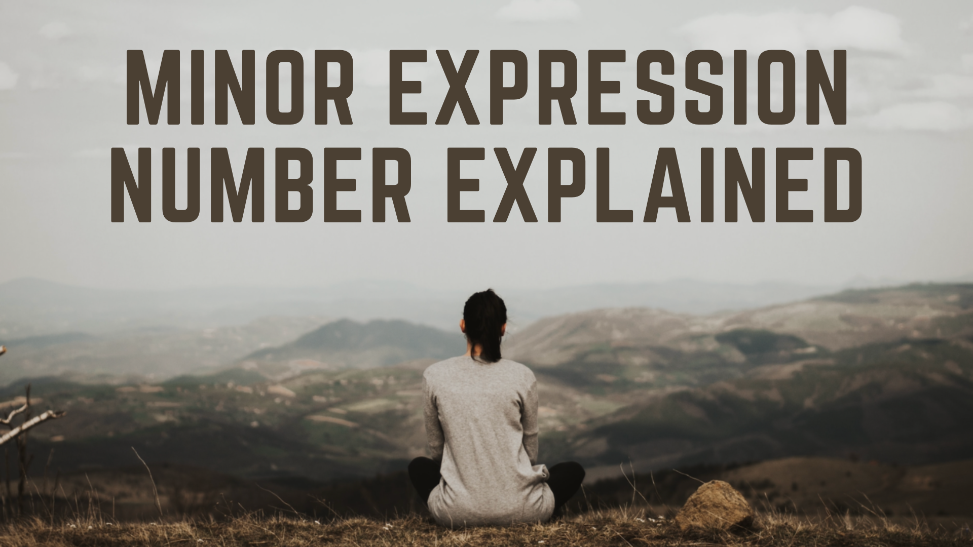 A woman sitting on the ground while looking at the mountains with words Minor Expression Number Explained