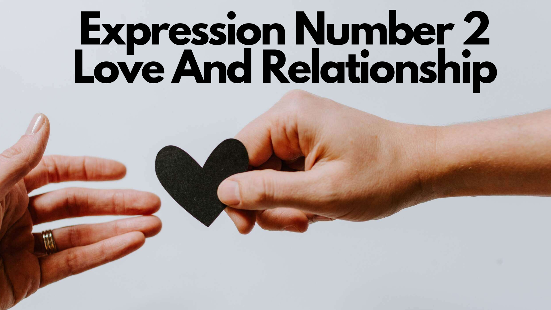 A person giving a heart shaped paper to other person with words Expression Number 2 Love And Relationship
