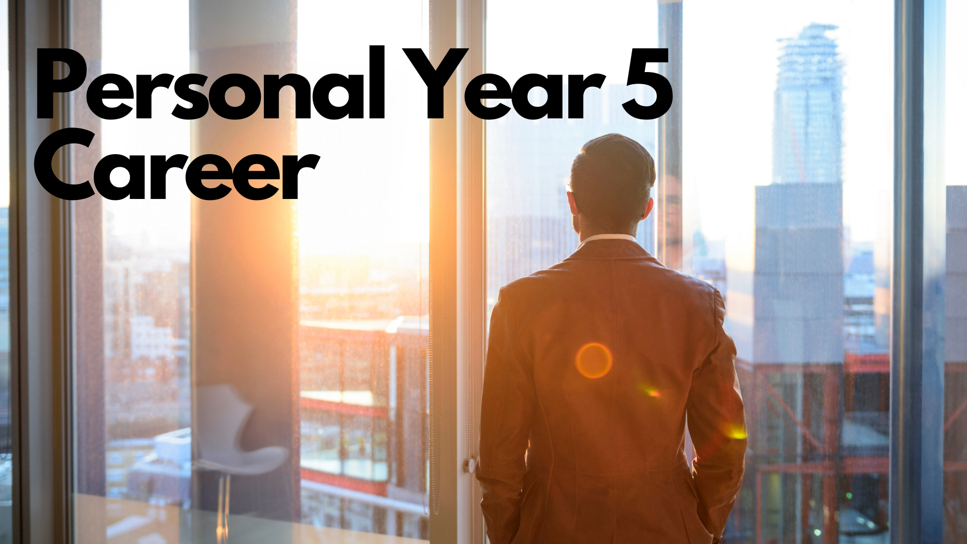 A man in a corporate attire looking at the glass overlookig outdoor buildings