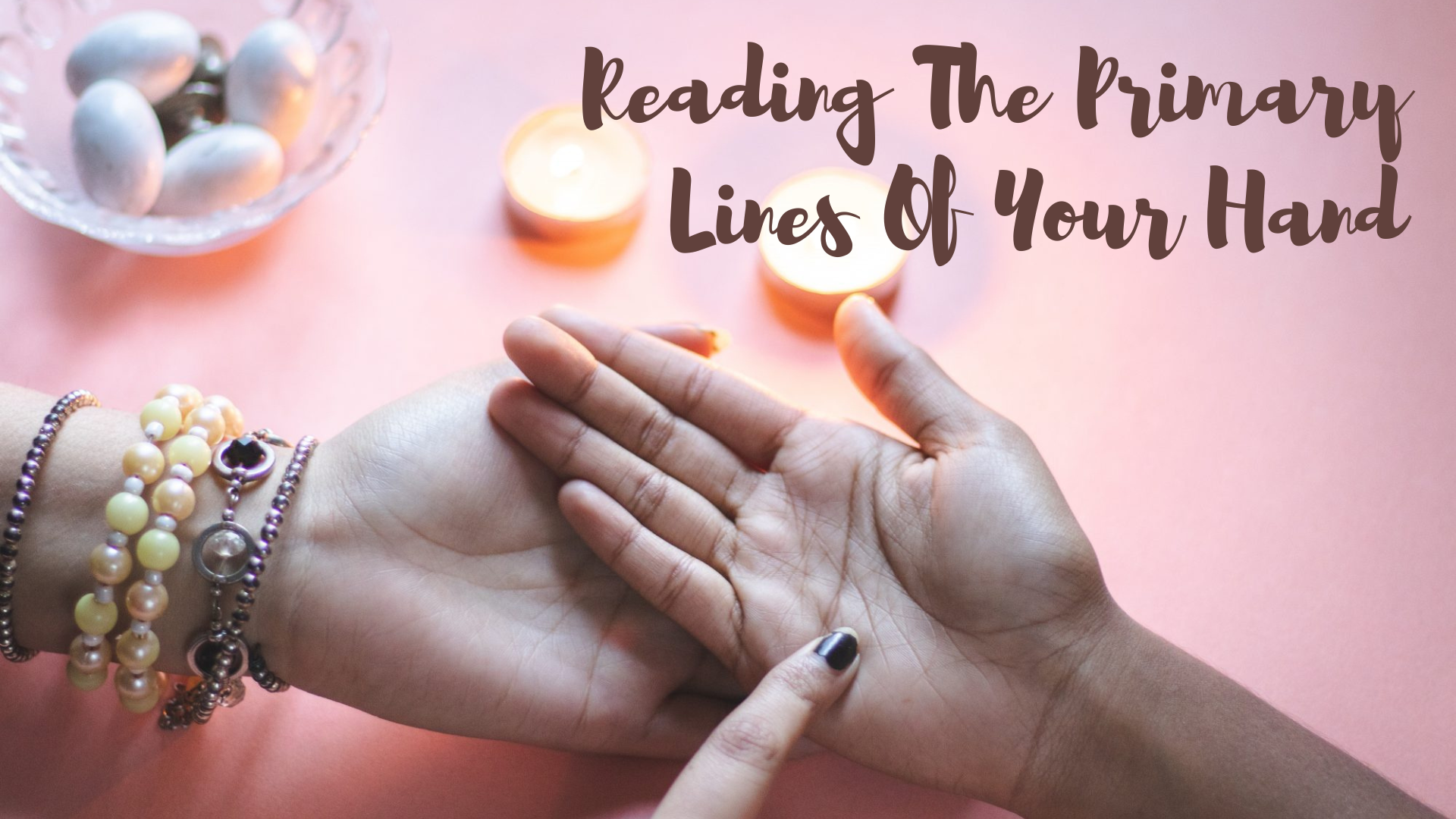 A woman holding the hand of other person and perfoming palm reading with words Reading The Primary Lines Of Your Hand